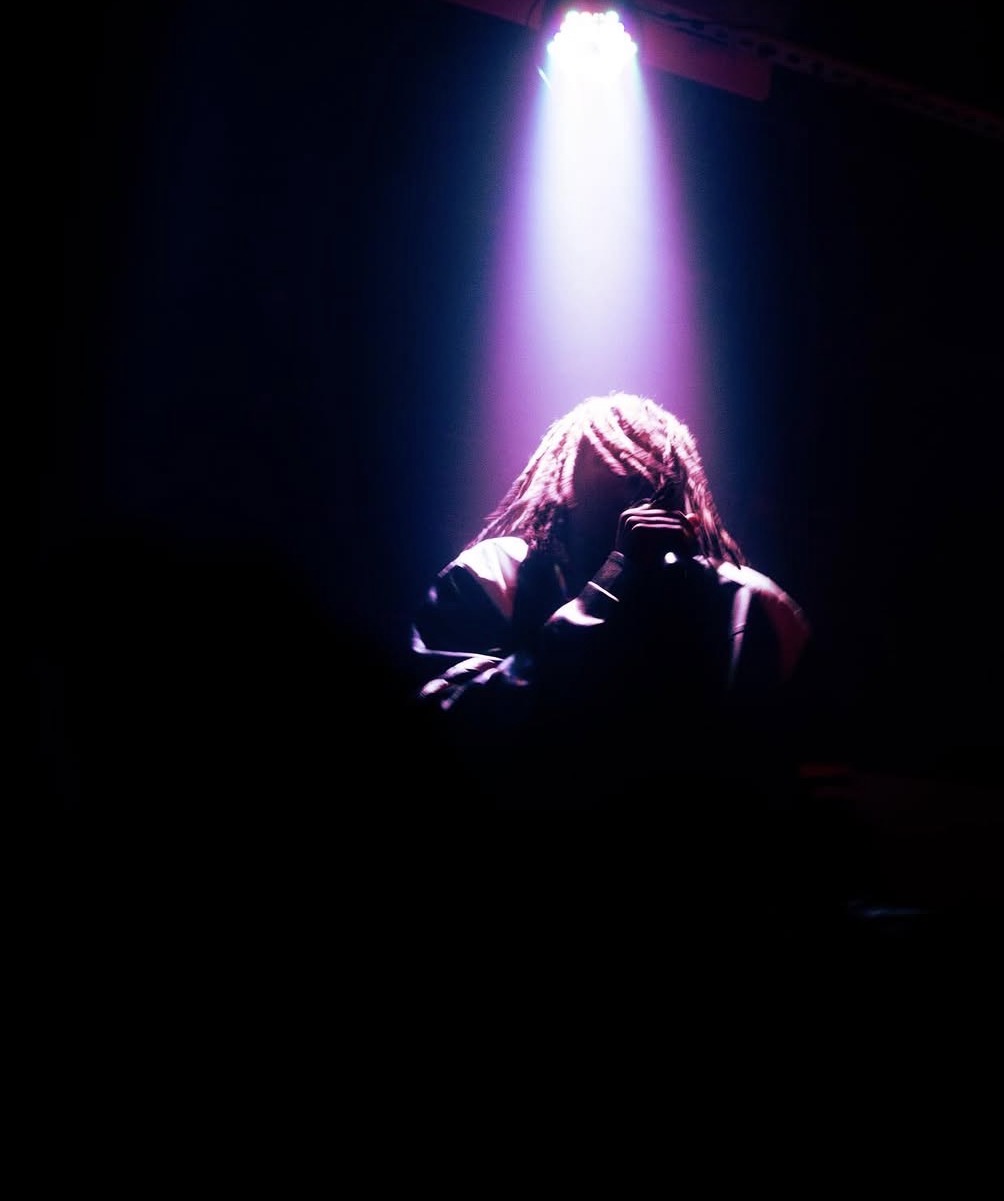 Zombieland — solo artist under a single purple spotlight