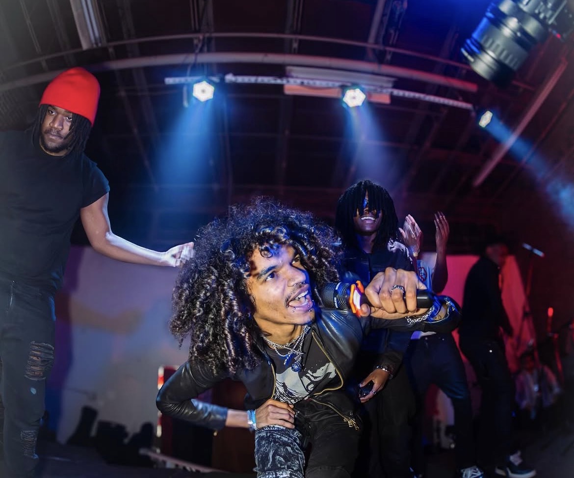 Zombieland — performer mid-roar with the crew under blue lights