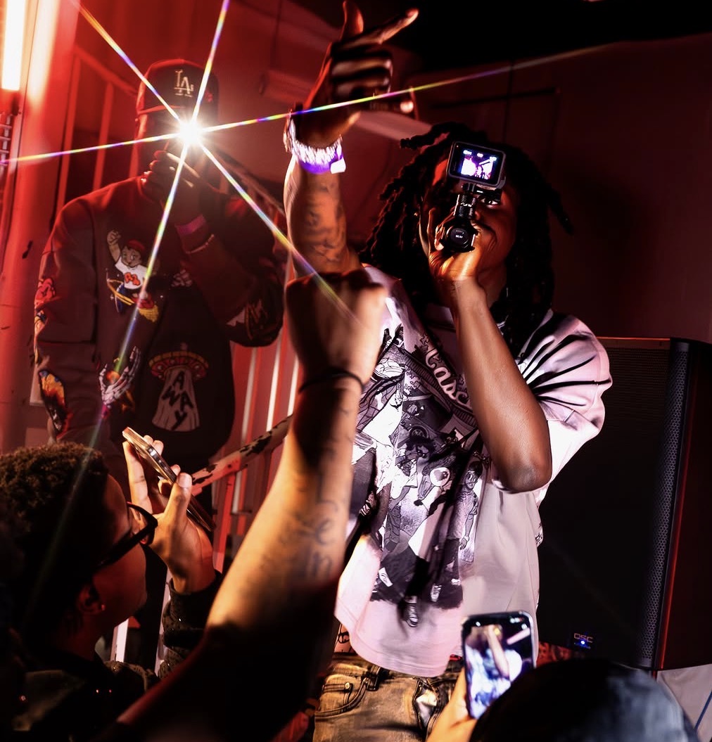 The Rally — artist on the mic with camera lights